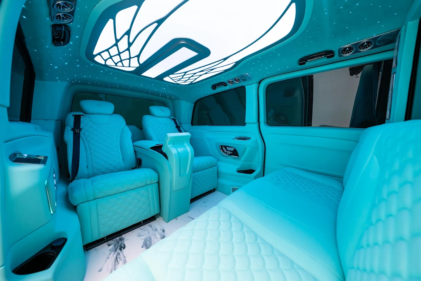 Cream leather lounge seating and starlight headliner inside an Aura Palm jet Sprinter
