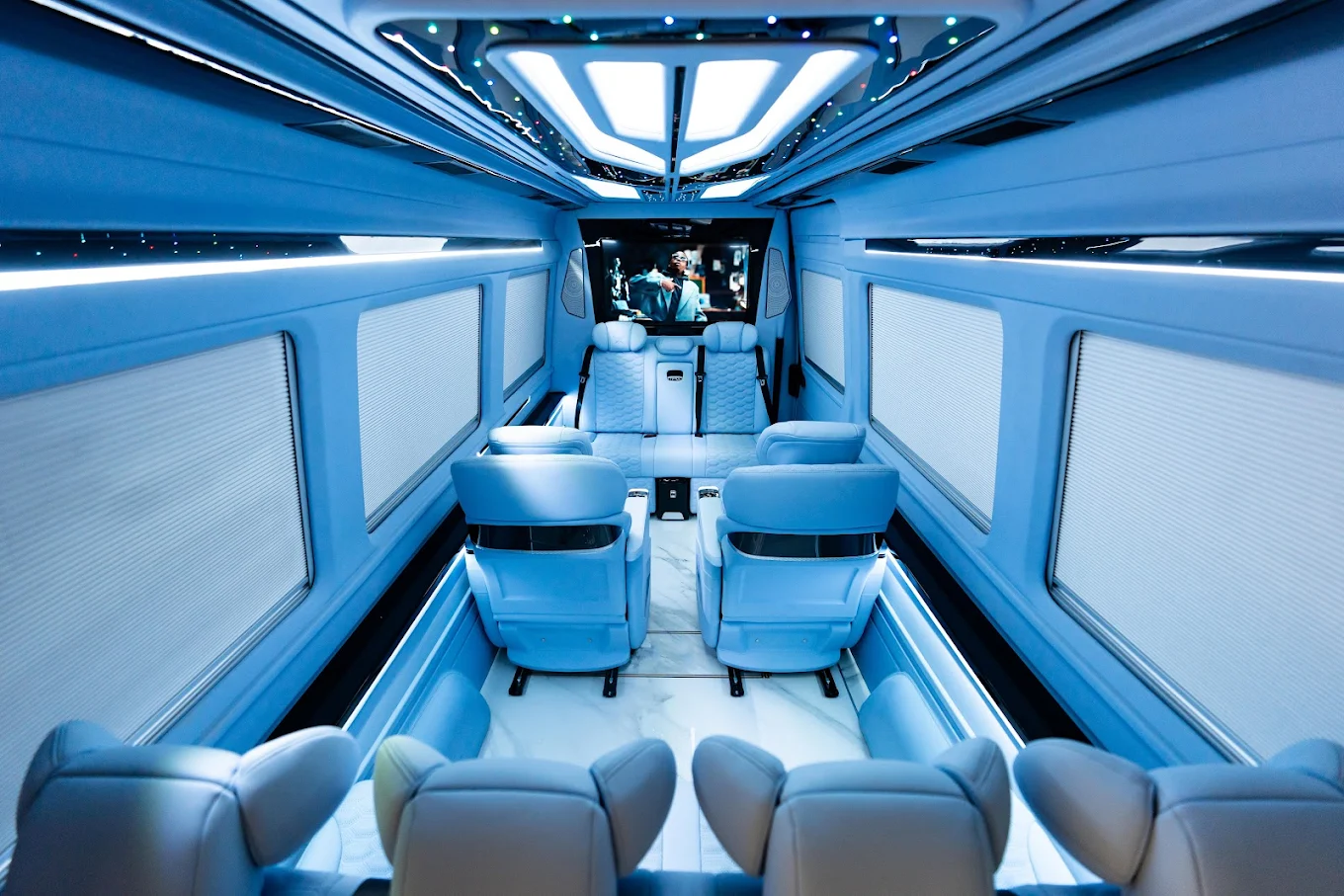 The cream-leather interior lounge of an Aura Palm Sprinter van